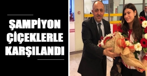 Şampiyon çiçeklerle karşılandı